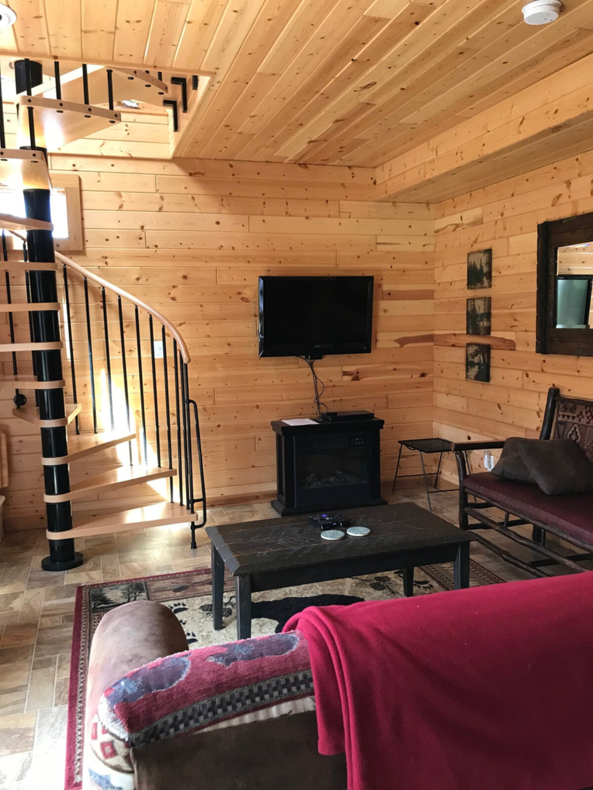 Downstairs entertainment room with spiral staircase